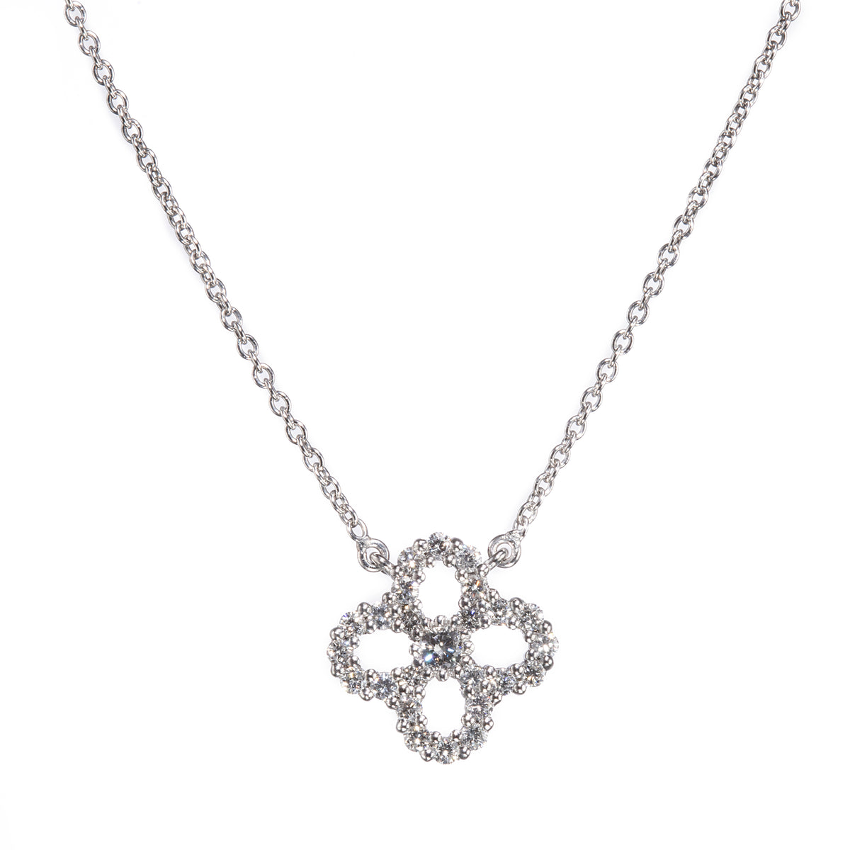 A white gold chain necklace with a four-petal clover pendant encrusted with small clear stones, shown against a plain white background.