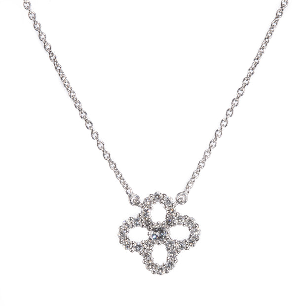 A white gold chain necklace with a four-petal clover pendant encrusted with small clear stones, shown against a plain white background.