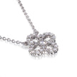A white gold necklace with a four-leaf clover pendant encrusted with clear round gemstones, shown on a clean white background with a soft reflection.
