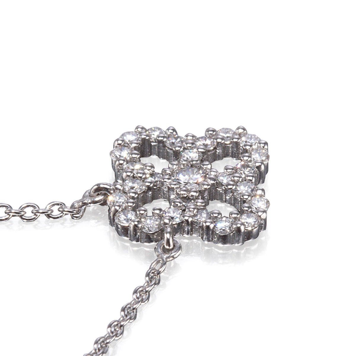 A white gold chain necklace featuring a clover-shaped pendant encrusted with clear round gemstones, shown on a clean white background.