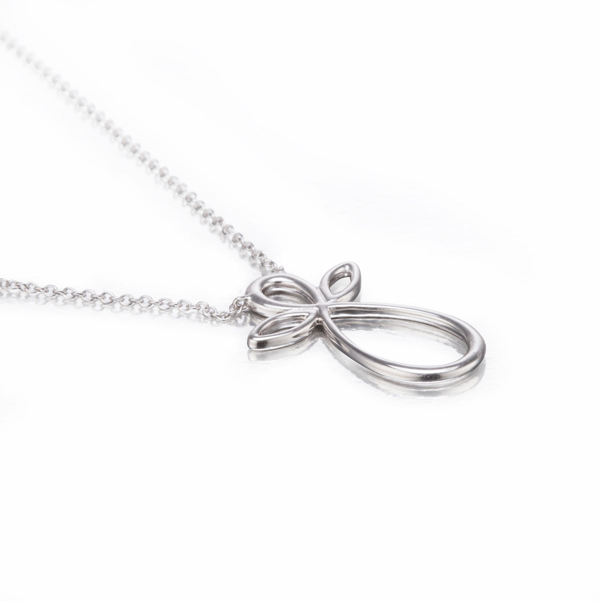 White gold bow-shaped pendant on a chain against a white background