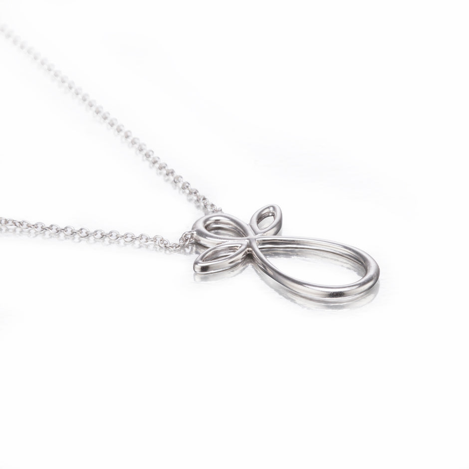 White gold bow-shaped pendant on a chain against a white background