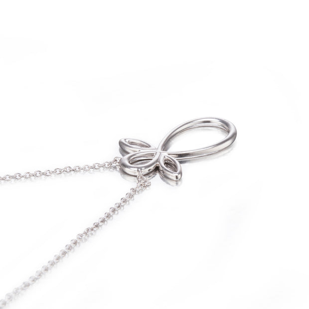 White gold bow-shaped pendant on a chain against a white background