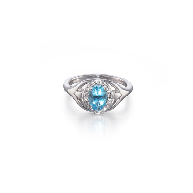 White gold ring with a blue gemstone on a white background
