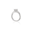 A platinum solitaire engagement ring with a round brilliant-cut diamond set in a four-prong setting, shown on a clean white background with a soft reflection below.