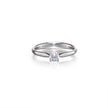 A platinum solitaire engagement ring with a clear round-cut gemstone, shown on a clean white background with a soft reflection.