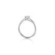 A platinum solitaire engagement ring with a heart-shaped clear gemstone, shown on a plain white background with a soft reflection below.