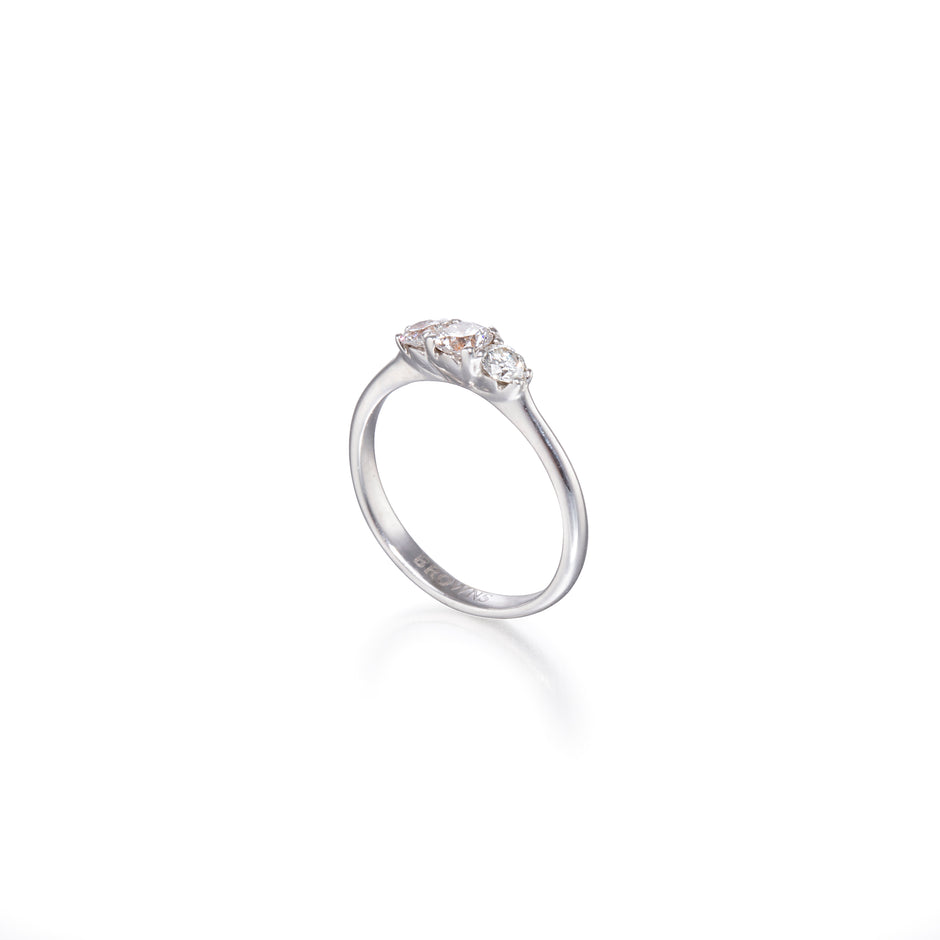 White gold ring with three diamonds on a white background