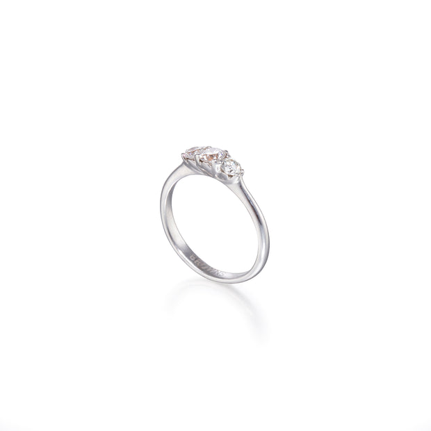 White gold ring with three diamonds on a white background