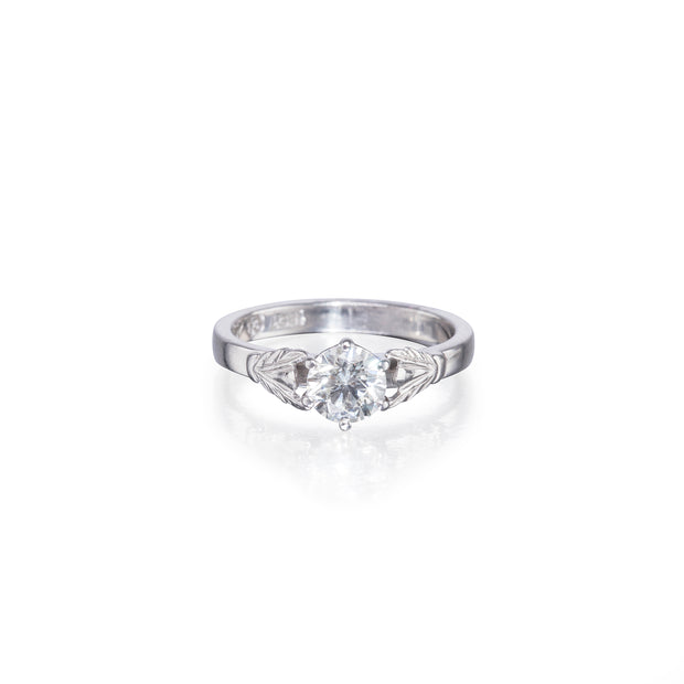White gold ring with a diamond on a white background