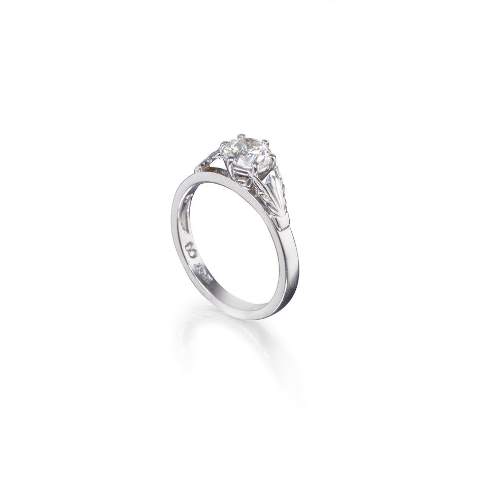 White gold ring with a diamond on a white background