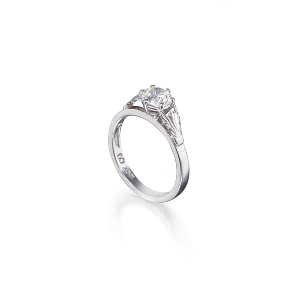 White gold ring with a diamond on a white background