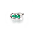 A Charles Greig Platinum ring featuring three round-cut green emerald-cut gemstones in a row, set against a clean white background with a soft reflection.