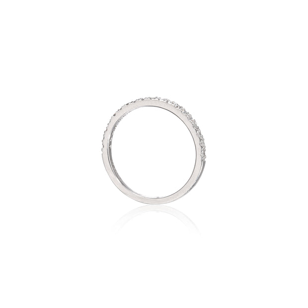 A white gold eternity ring with a continuous row of small clear stones, shown on a clean white background with a soft reflection below.