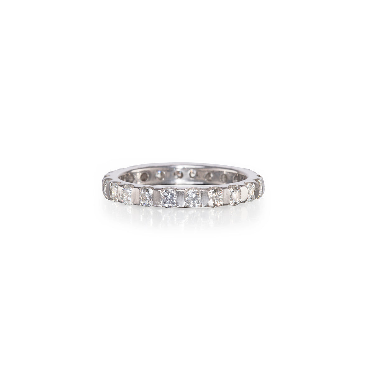 A white gold diamond eternity ring with a continuous row of round-cut diamonds on a plain white background