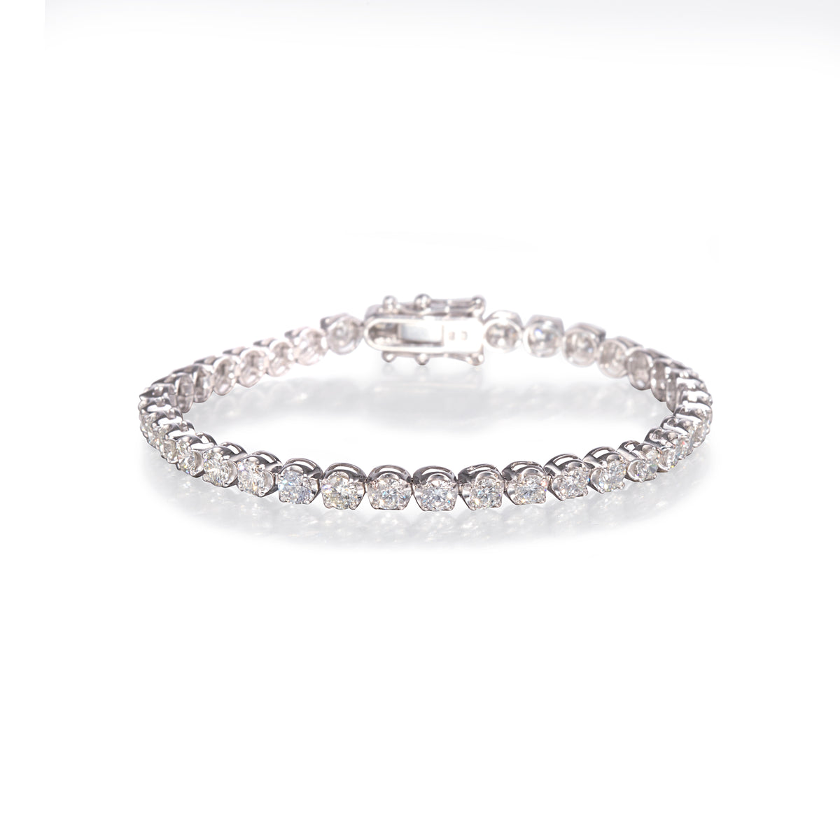 Handmade 18ct White Gold Diamond Tennis Bracelet, gold diamond bracelet with clear stones on a white background