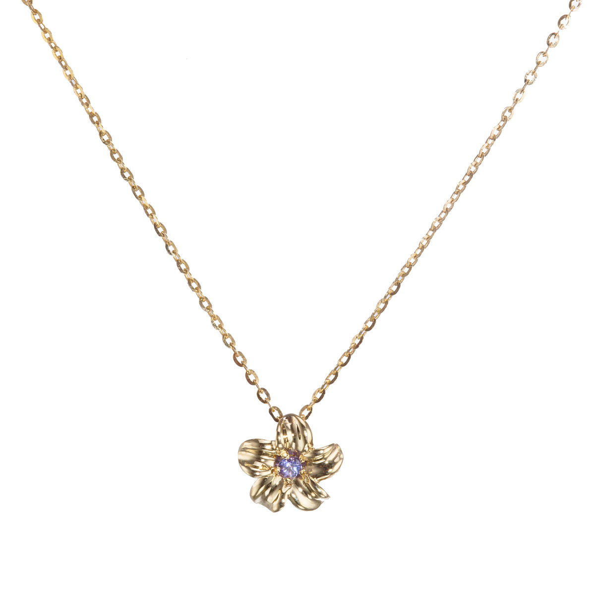 A delicate gold chain necklace featuring a small gold flower pendant with a tiny purple gemstone in the center, set against a plain white background.