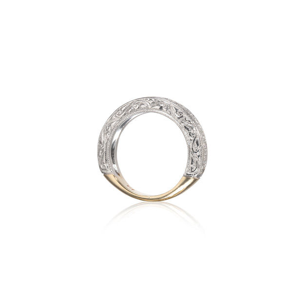 A two-tone ring featuring a white gold filigree band with a polished yellow gold base, shown on a clean white background with a soft reflection.