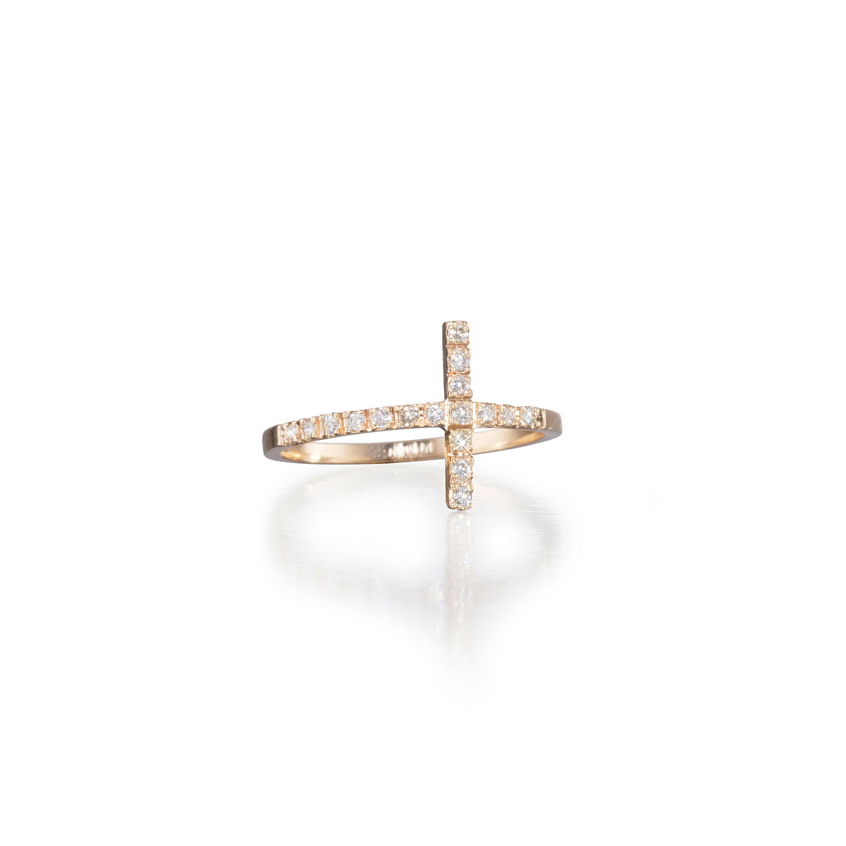 Gold cross-shaped ring with embedded diamonds on a white background