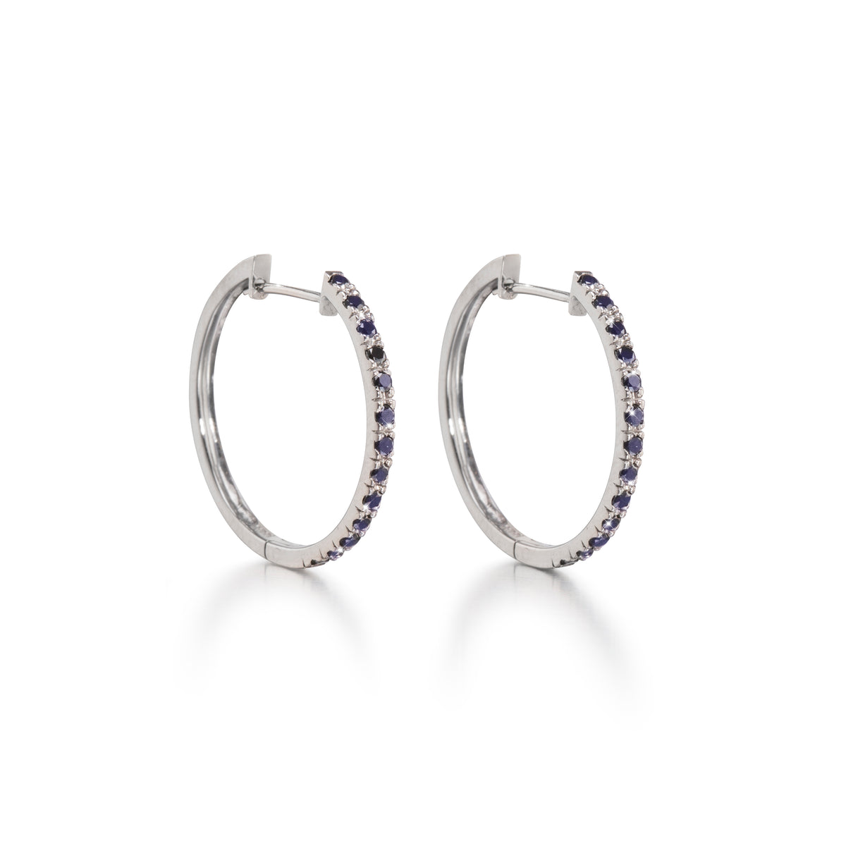 A pair of 18ct white gold black diamond huggie earrings with multiple black diamonds set in a hoop design.