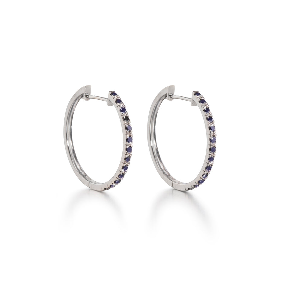 A pair of 18ct white gold black diamond huggie earrings with multiple black diamonds set in a hoop design.