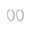 A pair of 18ct white gold black diamond huggie earrings with multiple black diamonds set in a hoop design.