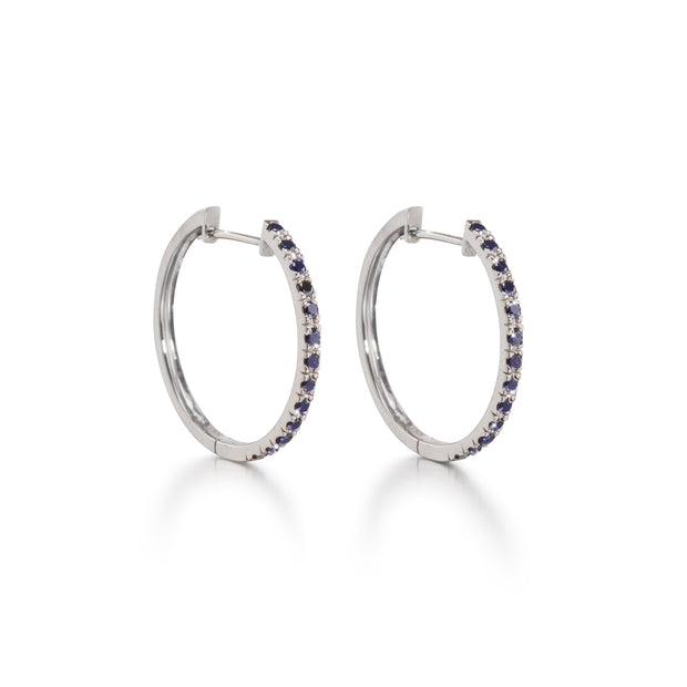 A pair of 18ct white gold black diamond huggie earrings with multiple black diamonds set in a hoop design.
