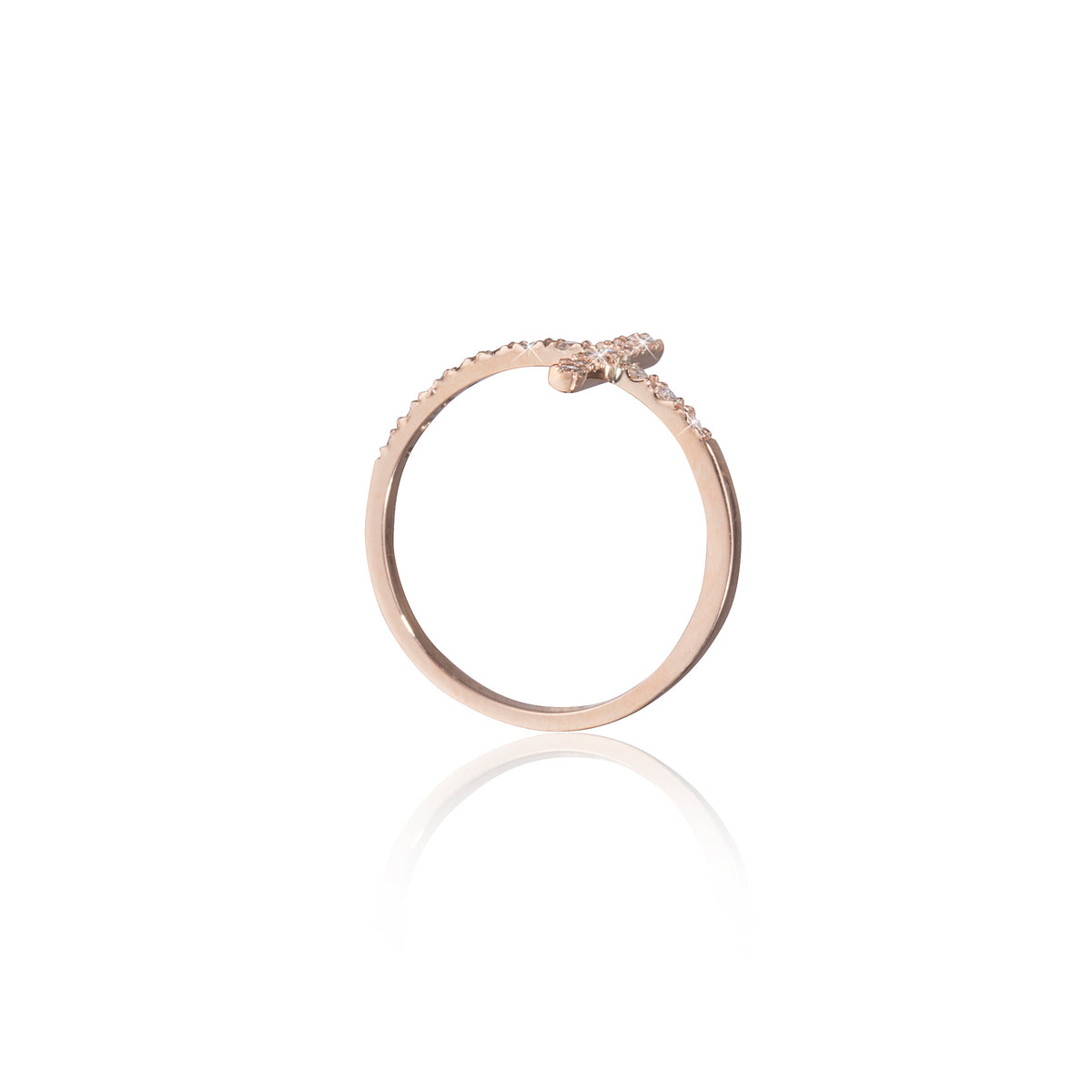 Rose gold ring with small diamonds on a white background