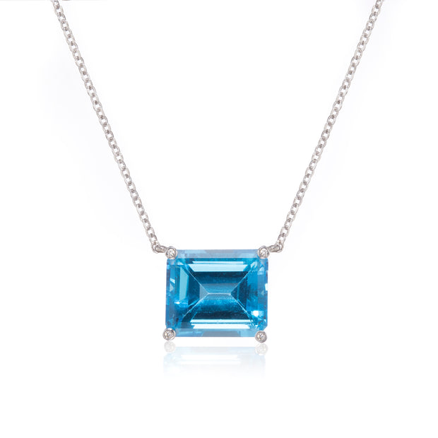 Necklace with a blue gemstone pendant on a white background