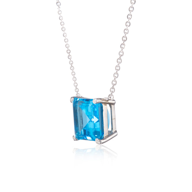 Necklace with a blue gemstone pendant on a white background
