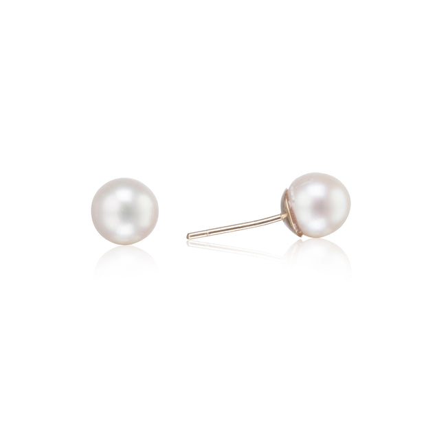 Pair of pearl stud earrings on a white background