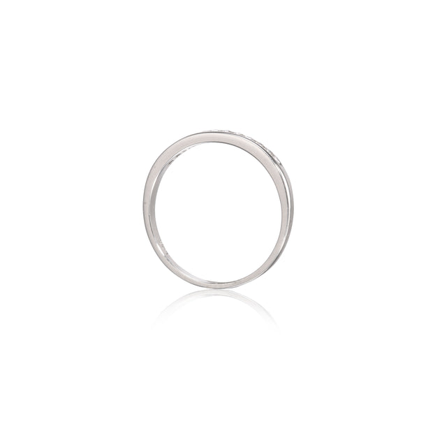 A minimalist white gold band ring with a subtle textured outer edge and a smooth polished inner band, shown on a clean white background with a soft reflection below.
