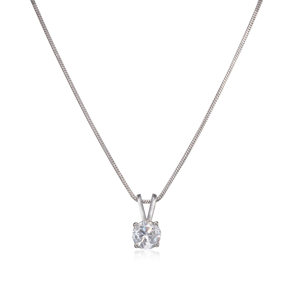 A white gold solitaire necklace with a round-cut clear gemstone pendant on a white background.