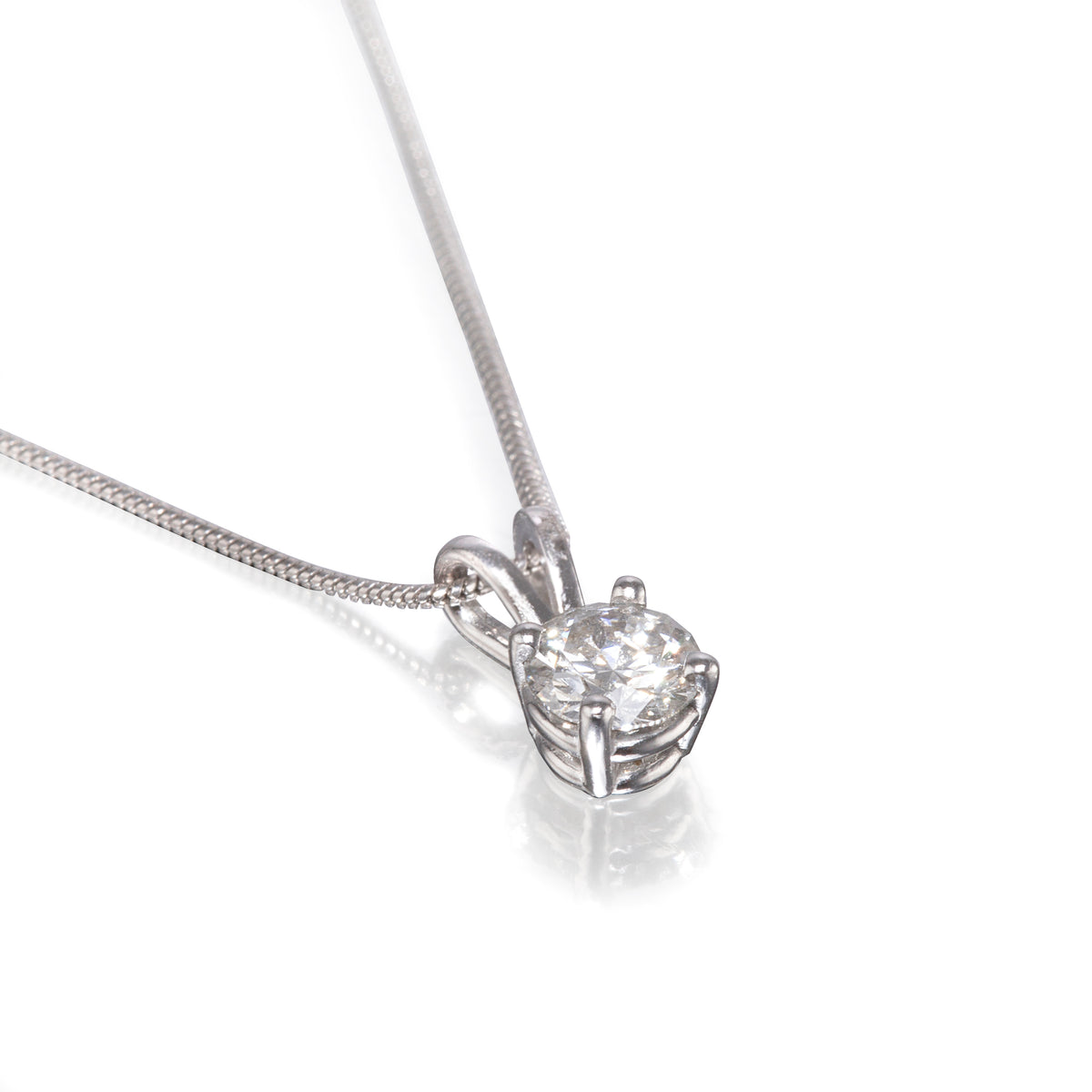 A white gold diamond pendant necklace on a delicate chain, set against a clean white background with a soft reflection.