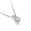 A white gold diamond pendant necklace on a delicate chain, set against a clean white background with a soft reflection.