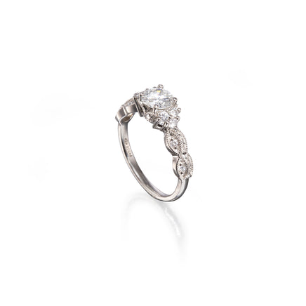A platinum diamond ring with a marquise-cut center stone and smaller diamonds along the shank, shown on a clean white background with a soft reflection.