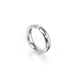 A polished platinum band ring with a single small clear gemstone set near the top, photographed on a clean white background with a soft reflection below