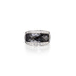 Ring with black gemstone and diamond-studded band on a white background