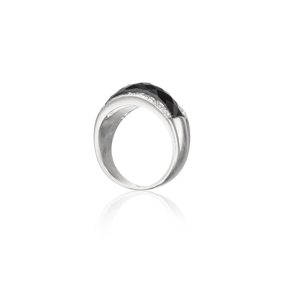 Silver ring with black gemstone on a white background