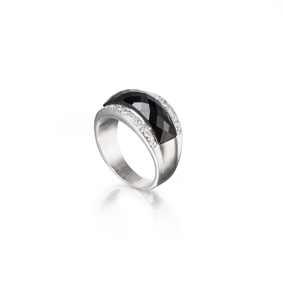 Silver ring with a black gemstone on a white background