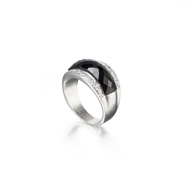 Silver ring with a black gemstone on a white background