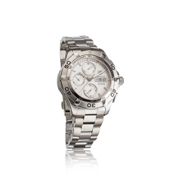 A stainless steel chronograph watch with a silver-tone metal link bracelet, featuring a white dial with multiple subdials, a rotating bezel, and a date window.
