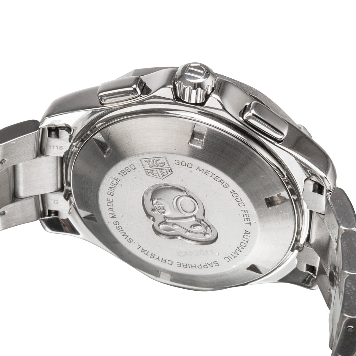 Close-up of the back case of a stainless steel wristwatch, showing engraved text and a logo mark on a clean white background.
