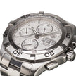 A close-up shot of a TAG Heuer Aquaracer automatic chronograph watch with a silver stainless steel case, white dial, and integrated link bracelet on a white background.