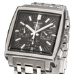 A Tag Heuer Monaco watch with a square stainless steel case, black dial, and matching steel link bracelet, shown on a white background.