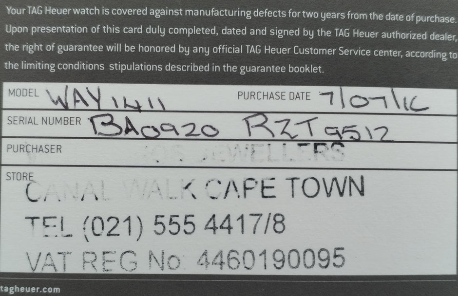 A close-up of a TAG Heuer watch warranty card with printed and handwritten text