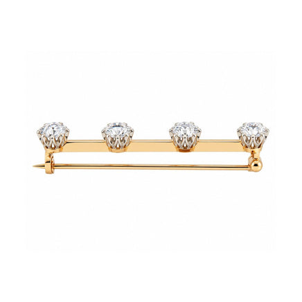 A yellow and rose gold bar pin featuring four round-cut clear gemstones set in a row, photographed on a solid white background.
