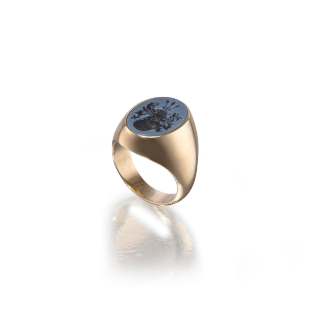 Gold ring with a blue stone on a white background