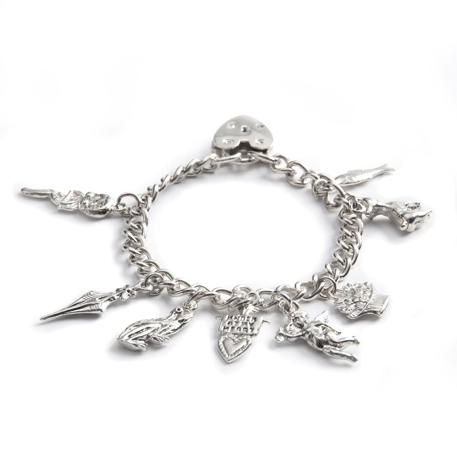 Silver charm bracelet with various charms on a white background
