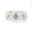 Pearl bracelet with diamond clasp on a white background